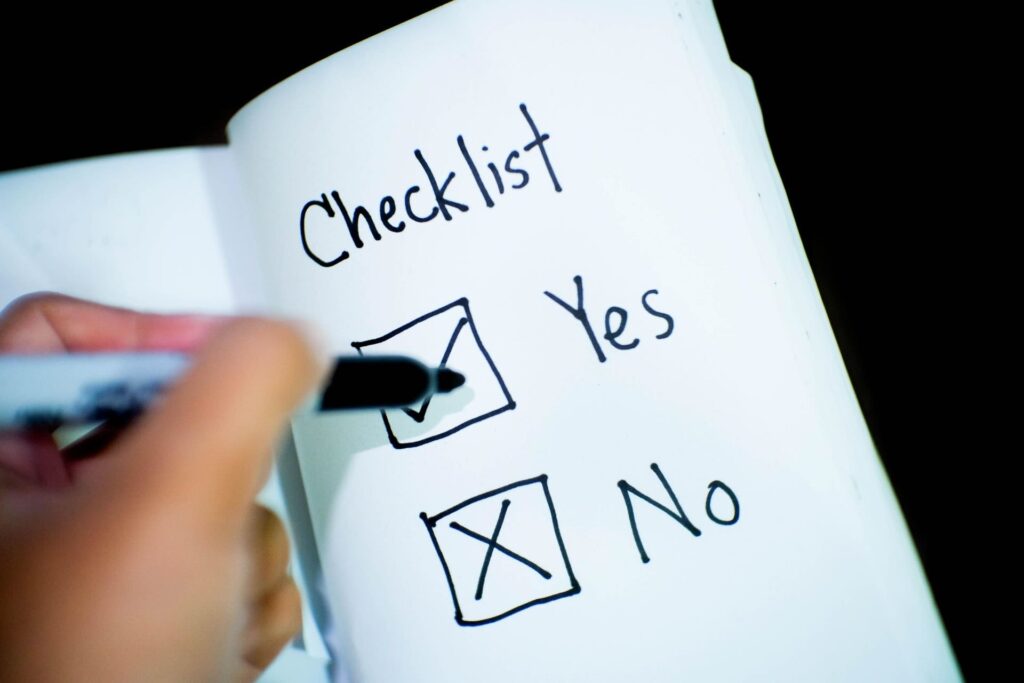 Handwritten checklist, black marker checking "Yes" box, "No" box marked with X - FAS Exteriors